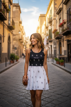Woman walking down a sunlit street in an urban setting