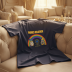 Navy blue t-shirt with rainbow design and text on a beige sofa in a living room.